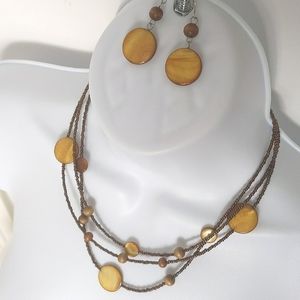 Triple strand brown and gold colored necklace with matching pierced earrings
